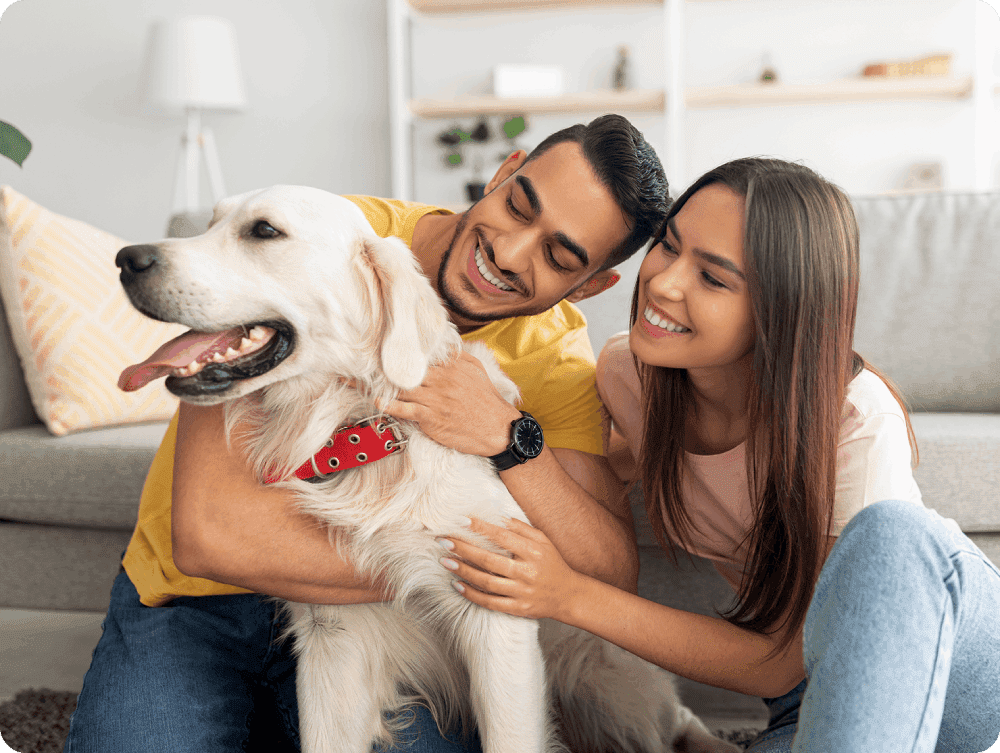 A man and woman petting their dog.